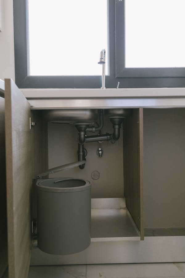 Under-sink plumbing showing drain and trap