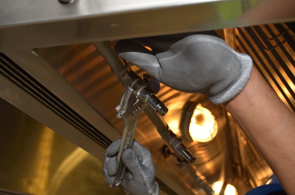Plumber working on industrial pipework during a renovation